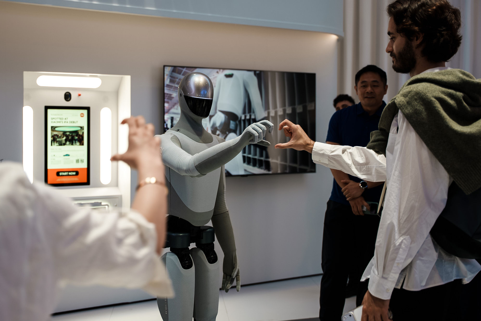 Visitor interacting with a humanoid robot at IFA Berlin 2026.