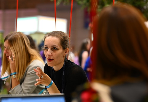Attendees in conversation at MEO Arena during day one of Web Summit 2024 in Lisbon; past edition.